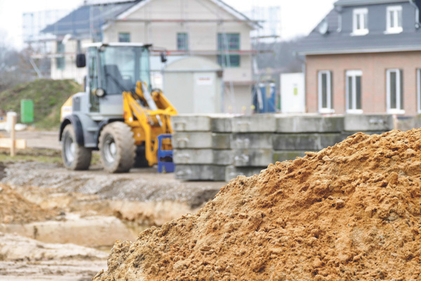 Baustelle Wohnungsbau Bagger Baumaterialien