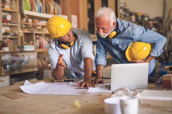 Generationenübergreifende Handwerkskunst Meister und Lehrling in der Werkstatt